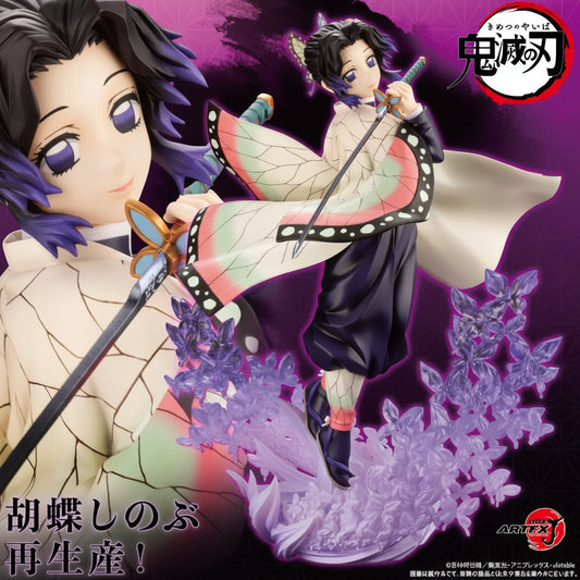 Anime collectible figure of Tanjiro Kamado from Demon Slayer, shown in a dynamic pose with a sword and butterfly-themed accessories against a purple and black background. The figure has dark hair, a cream and black patterned top, dark pants, and is surrounded by purple energy effects and floral elements.