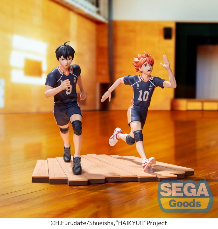 Two anime-style figures of volleyball players on a wooden floor with 'SEGA Goods' logo.