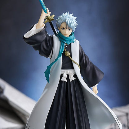Figurine of a character in traditional attire holding a sword against a dark background
