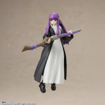 Action figure with purple hair and a long coat holding a broom against a beige background