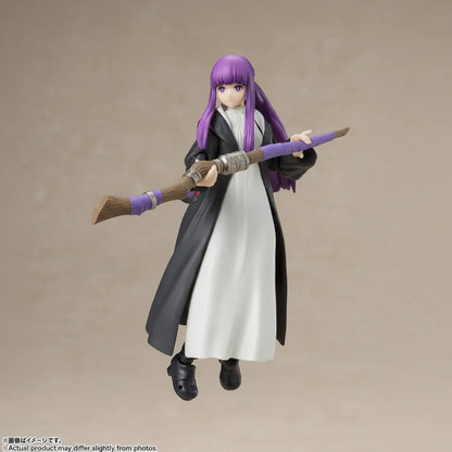Action figure with purple hair and a long coat holding a broom against a beige background