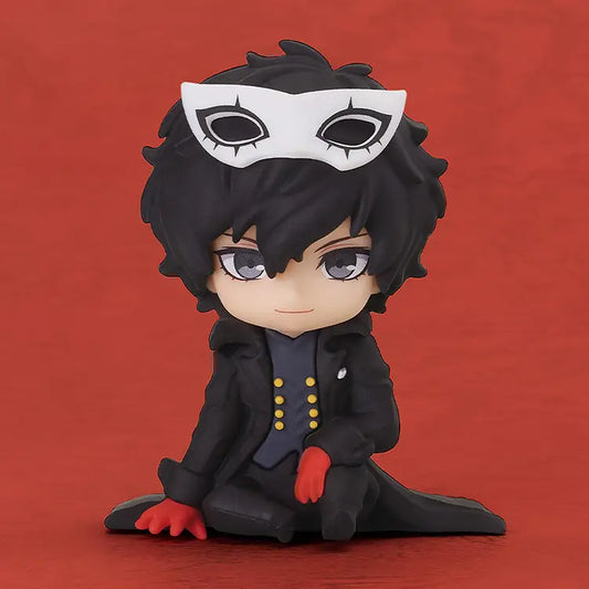 A chibi-style collectible figure of a dark-haired character wearing a white masquerade mask, black coat, and red gloves, posed against a solid red background.
