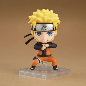 Action figure of a character with spiky yellow hair and blue eyes, wearing an orange outfit and headband.