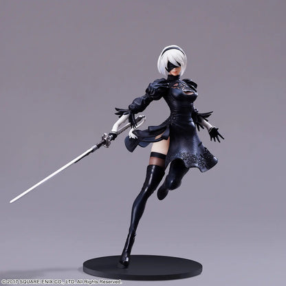 Action figure in black outfit with a sword on a gray background