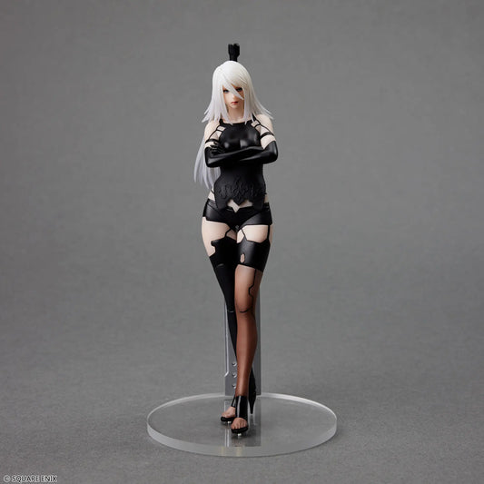 Action figure of a character in black and white attire on a gray background