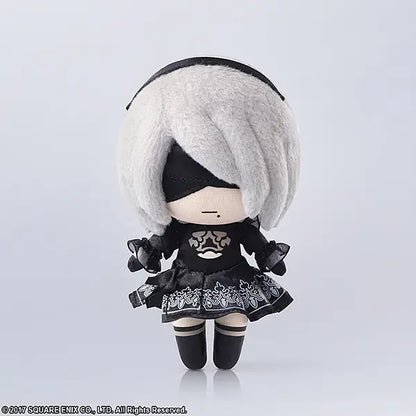 Plush toy with white hair and black outfit on a light gray background