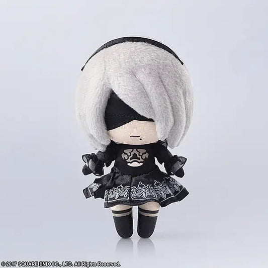 Plush toy with white hair and black outfit on a light gray background