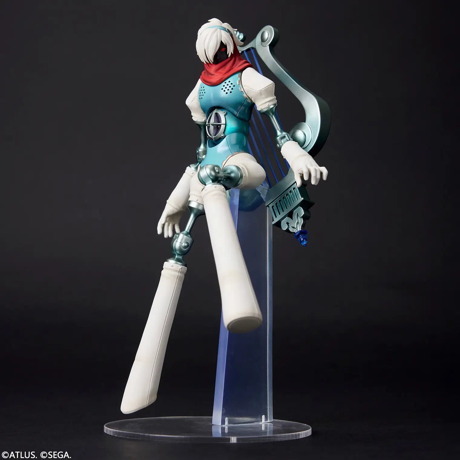 A stylized articulated action figure of a sci-fi female character posed on a clear acrylic display stand against a dark studio background. The figure has white hair, a red scarf, a teal and white bodysuit, and a large curved silver weapon accessory.