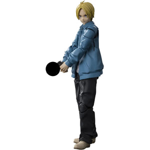 Action figure of a character in a blue jacket holding a gu^ on a white background