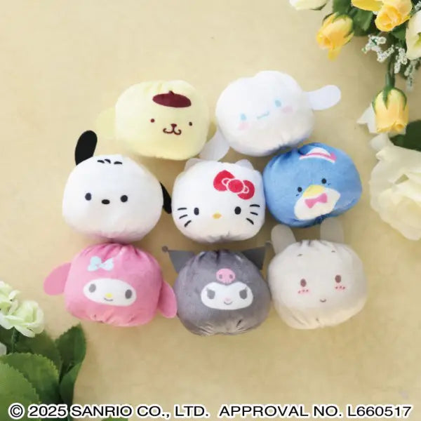 Set of small plush toys with various designs on a beige background