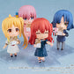 Four anime-style figurines with different hairstyles and outfits on a light blue background.