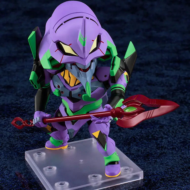 A stylized purple and green mecha figurine holding a red spear, mounted on a clear plastic display base against a dark blue textured background.