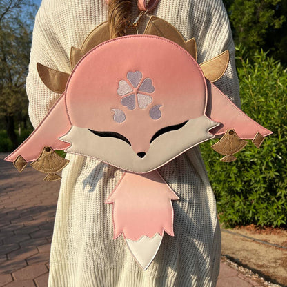 Person wearing a pink backpack with a cartoon character design outdoors.