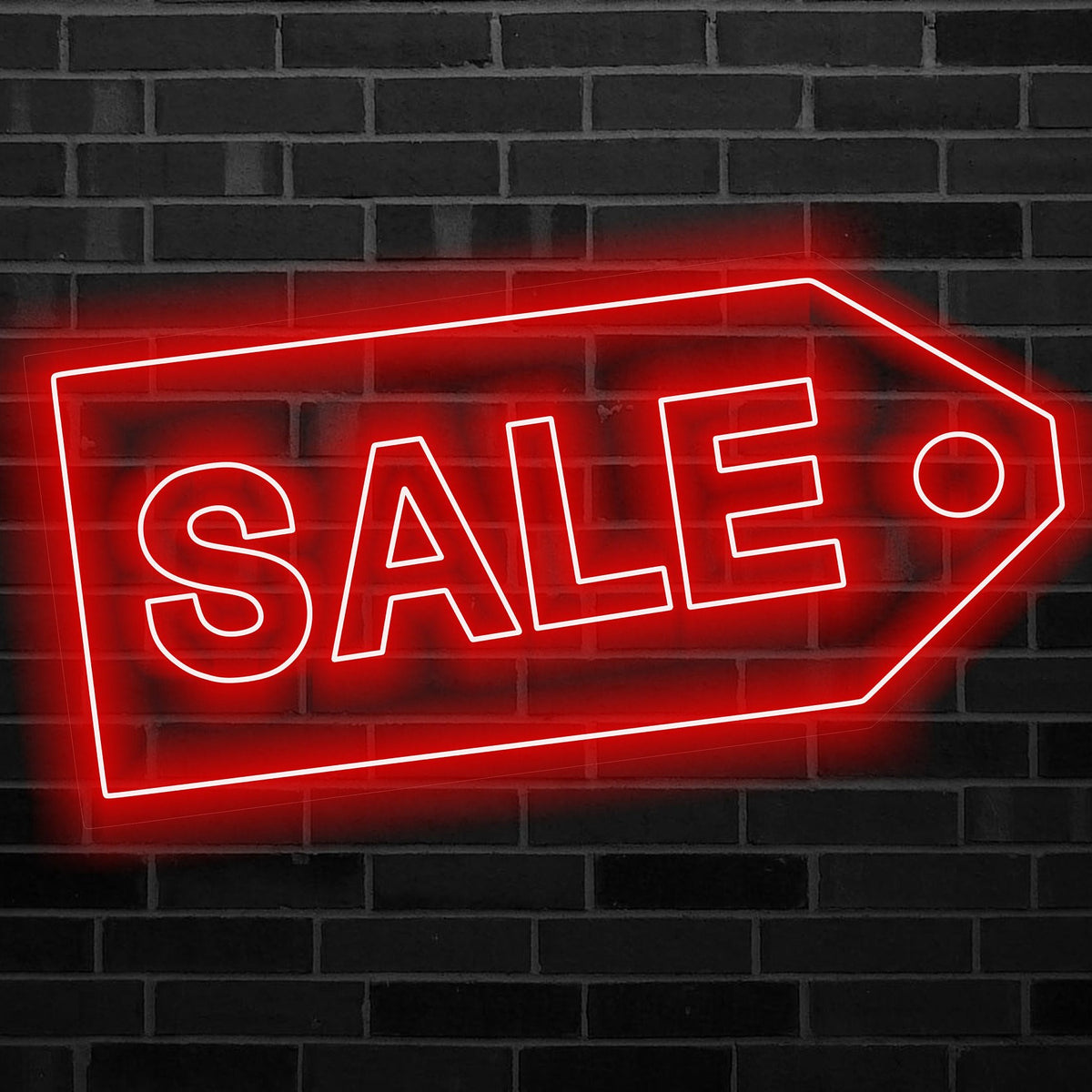 A neon sale sign on brick
